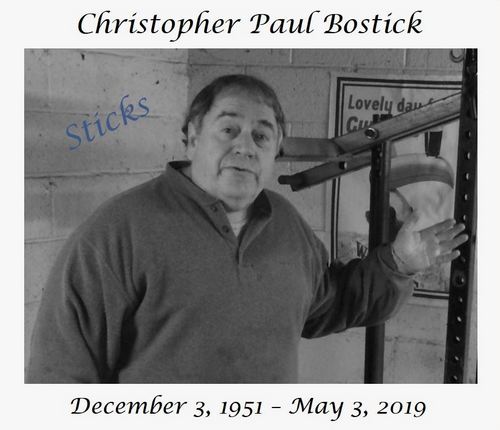 Chris Paul Bostick in his garage gym and standing in front of his leverage muscle-building machine.  Above the photo reads Christopher Paul Bostick. Below the photo reads December 3, 1951 - May 3, 2019.