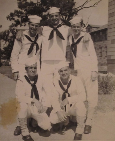 Clarence Harrison kneeling in uniform and hat with Navy buddies