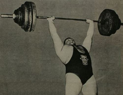 Doug Hepburn pressing a 410-barbell overhead with perfect form.