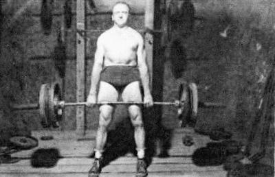 Bob Peoples completing a heavy deadlift in his cellar home gym.
